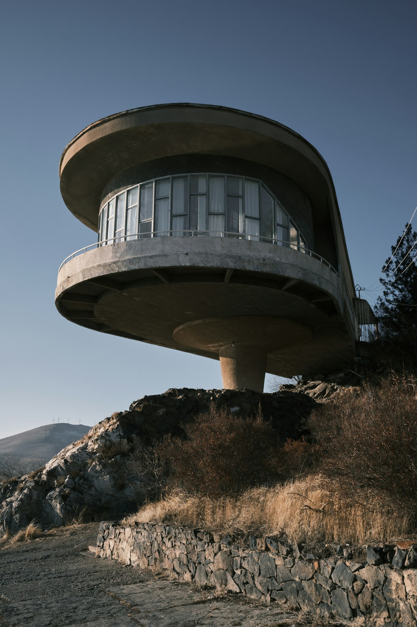 a round building with a balcony on top of a hill, Ultra