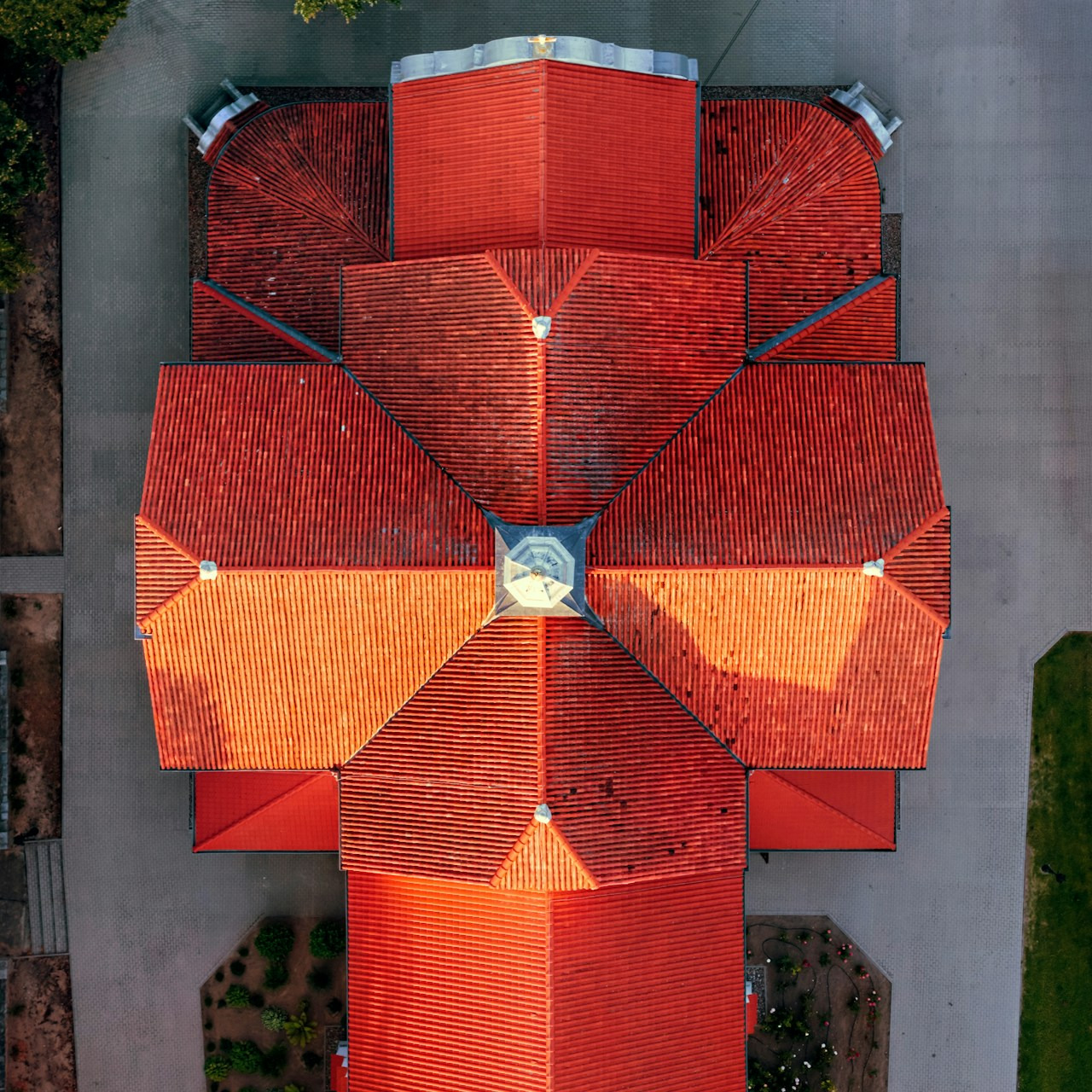 An aerial view of a building with a complex red tiled roof, Ultra