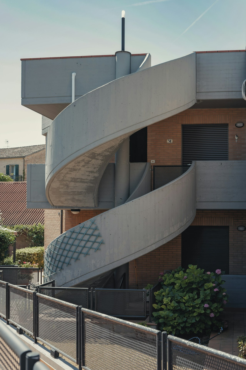 Exterior concrete spiral staircase on a brick building, Ultra