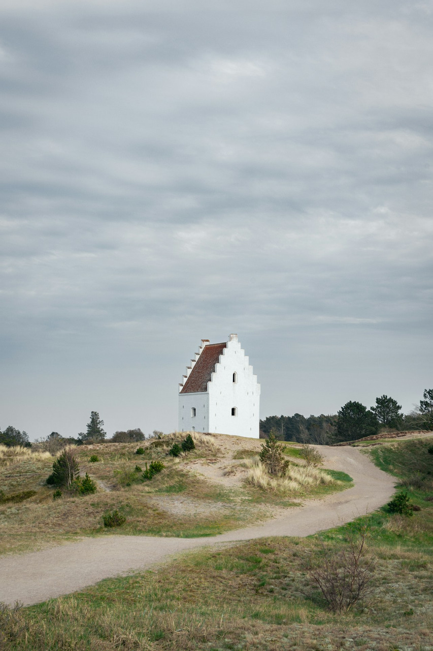Historic white church building on a sandy dune landscape, Ultra