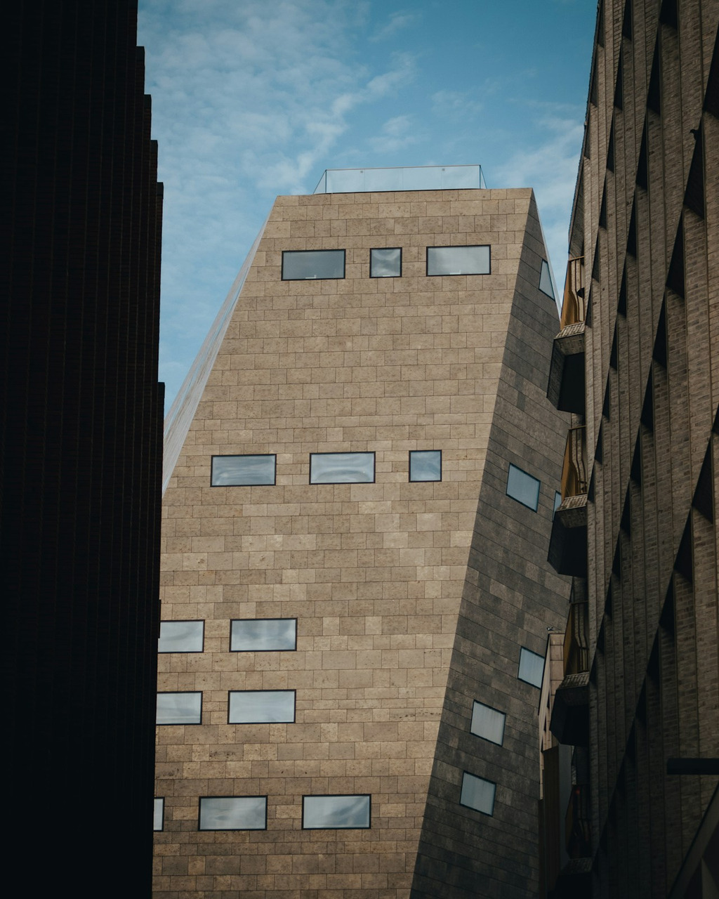 Modern building with unique angular architecture and stone facade, Ultra
