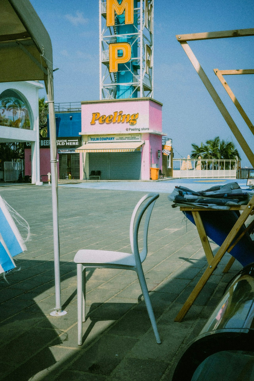 Outdoor seating area with amusement park background, Ultra