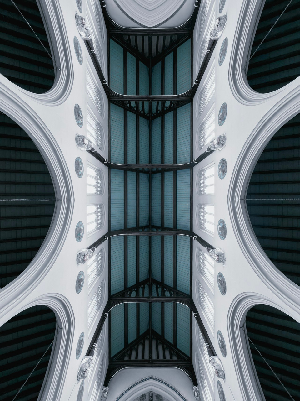 The vaulted ceiling of St Mary's Church in Derby with blue panels and arches, Ultra